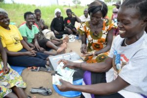 Photo: Members of a women savings group count the money raised in one seating. ©2018 World Vision, Moses Mukitale.