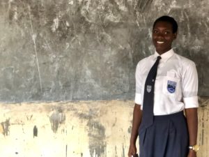 Pricilia stands in front of the white board in the girls' study room, which she advocated for. Girls education and empowerment concept