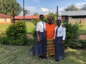 Pricilia, Rita (World Vision Project Director), and Karen (Pricilia's classmate and friend) girls education and empowerment