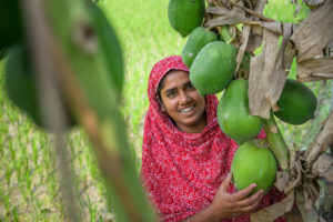 Fatema, 32, with her papaya fruit trees.