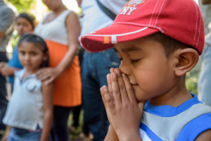 Central American child prays
