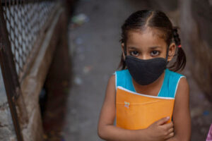 young girl in India wearing mask